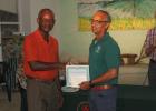 Russell Corrie, Director of Nature Care, which maintains the Warrens roundabout, accepting his prize from the President of the Barbados Horticultural Society, Orson Daisley.